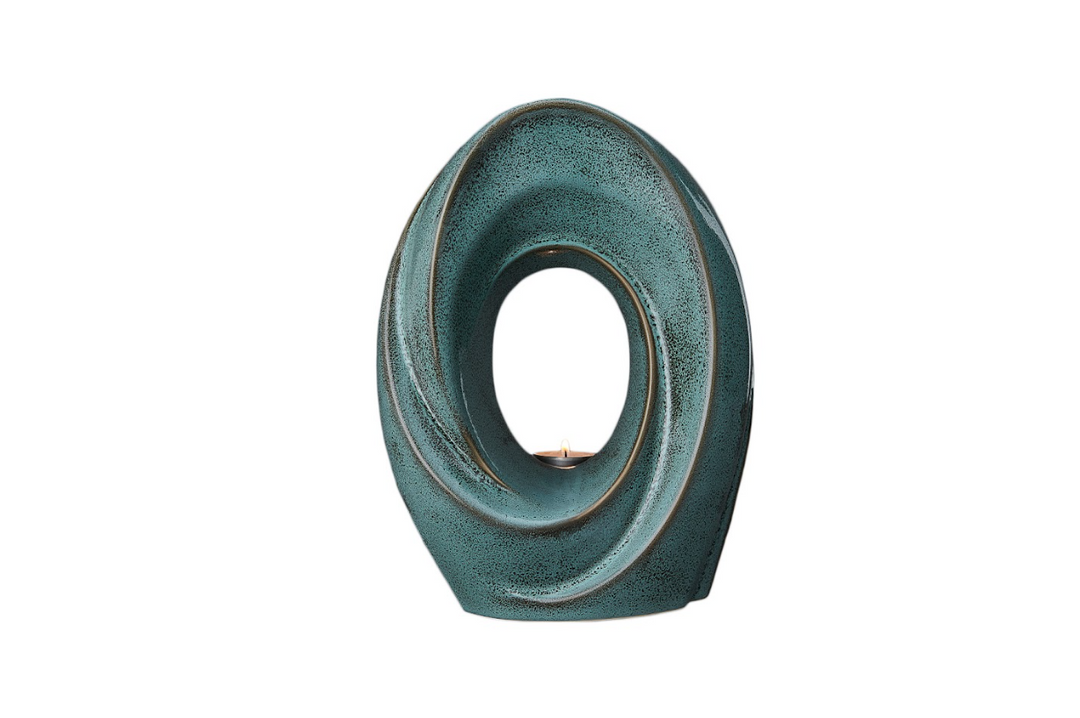 Teal The Passage ceramic urn with an inward spiral and built-in candle holder visible through the center.