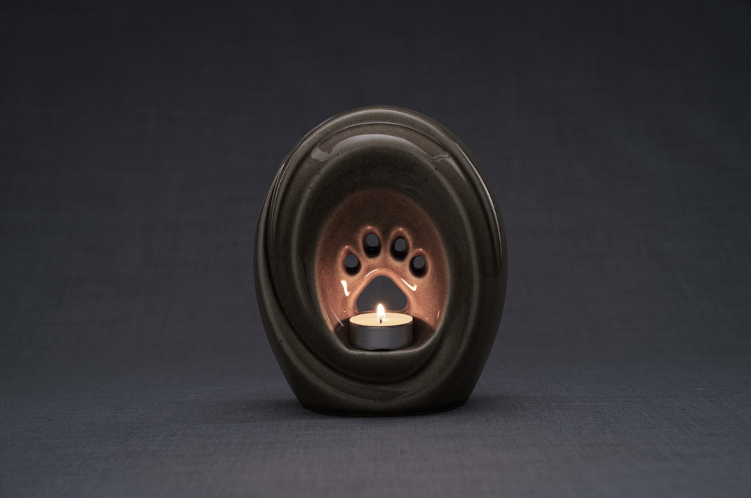 Brown ceramic Paw Urn for pets with a built-in candle holder and paw print interior
