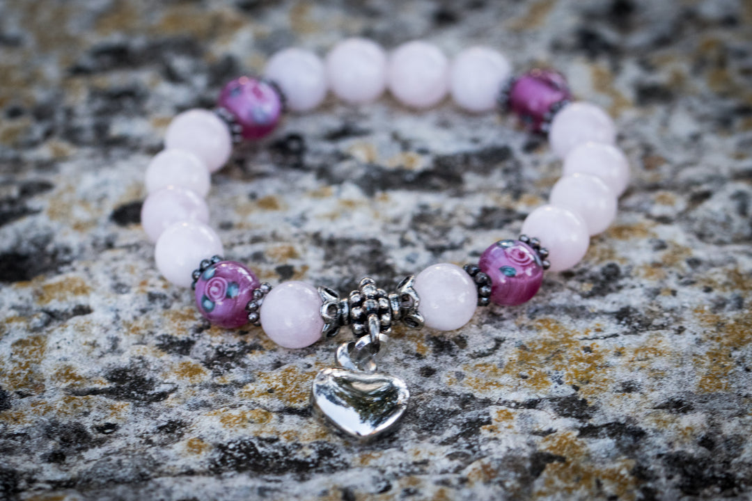 Rose quartz and floral keepsake urn heart bracelet with pink patterned beads and a silver heart charm.