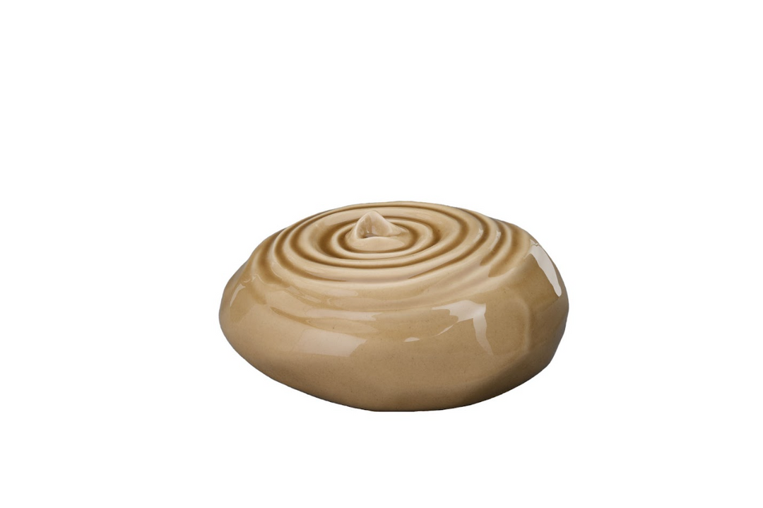 Resonance Ceramic Urn in warm beige glaze with circular ripple pattern on top, bottom-filled.