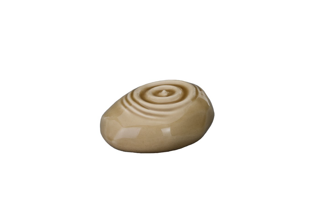 Pale beige Resonance Ceramic Urn featuring concentric spiral ridges on a smooth pebble surface