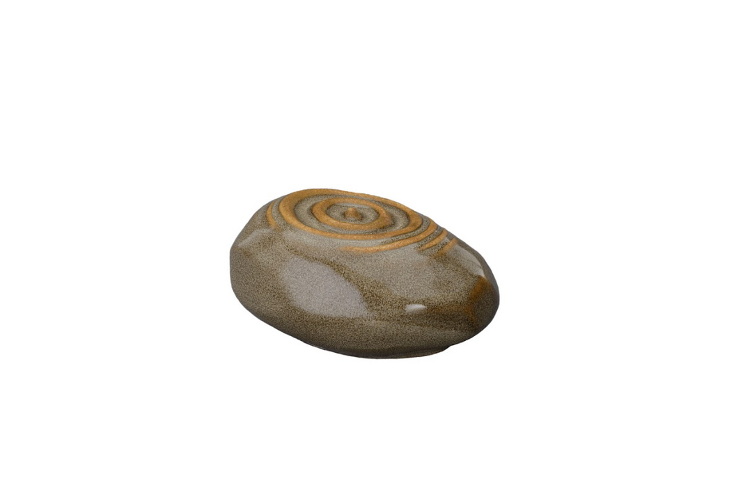 Beige Resonance ceramic urn featuring orange spiral pattern on top, angled view