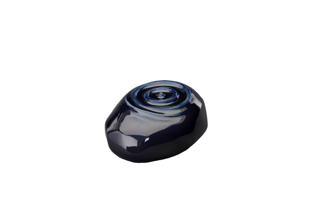 Deep navy Resonance ceramic urn with a glossy finish and raised spiral rings on the top surface