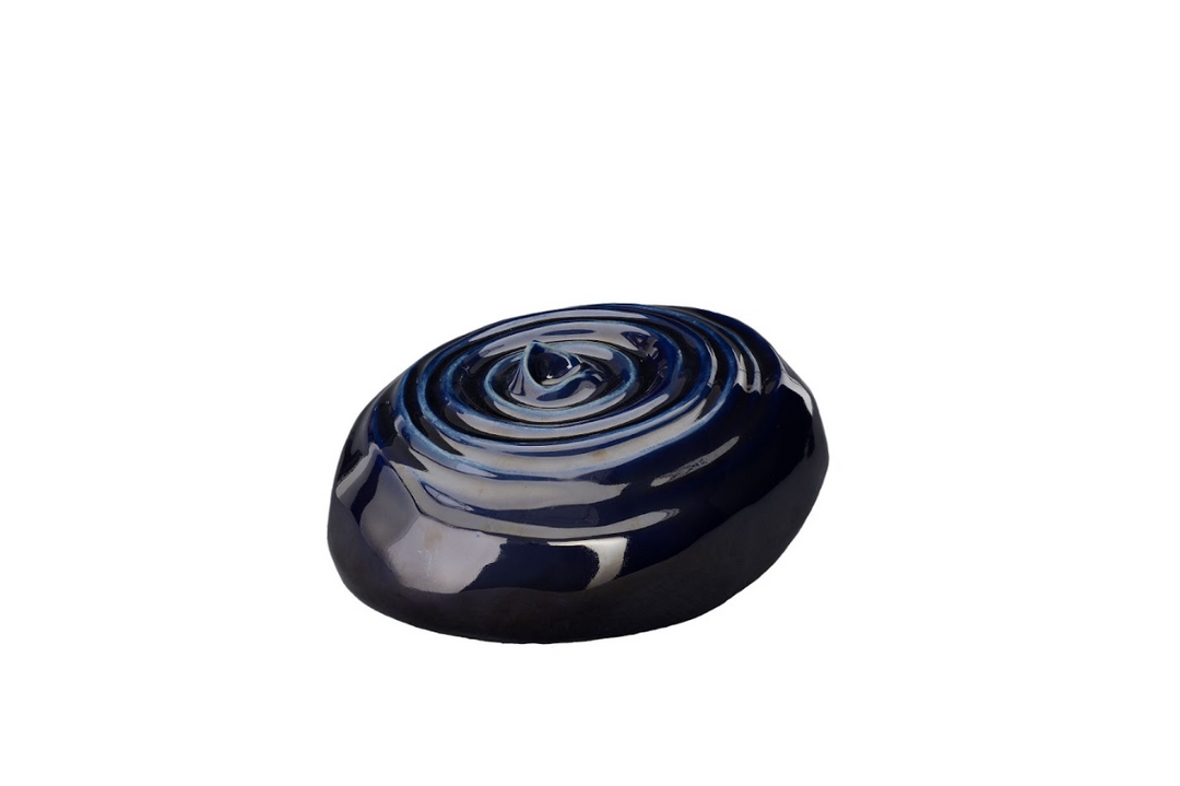 Deep blue glossy ceramic urn with a swirling spiral pattern on its top surface.