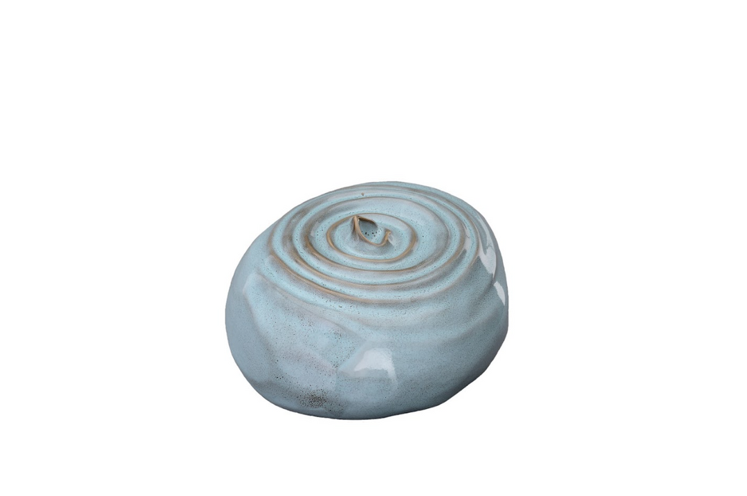 Light blue ceramic urn with a raised concentric spiral on the top and a smooth rounded body.