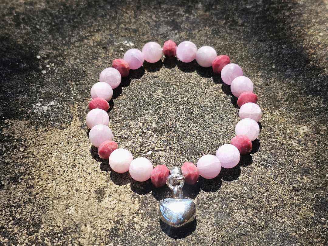 Rhodonite and kunzite bead bracelet with a silver heart keepsake charm on pink beads.