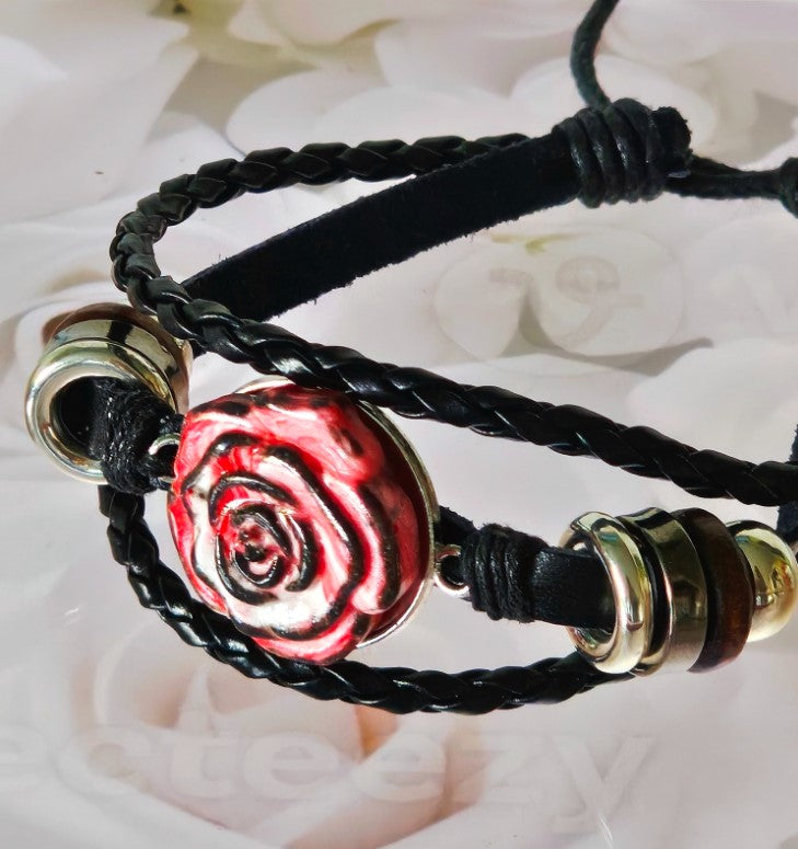 Colorful rose bracelet with a red rose centerpiece on a leather and jewelry cord band infused with cremation ashes