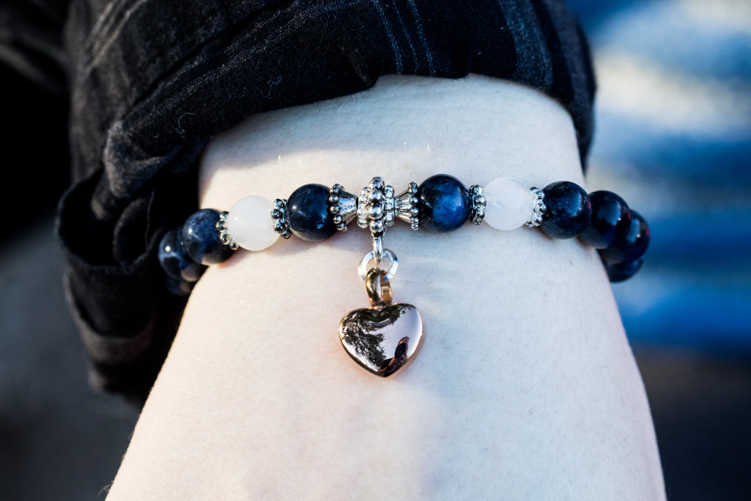 Sodalite and snow quartz keepsake urn heart bracelet with dark blue and white beads and a silver heart charm.