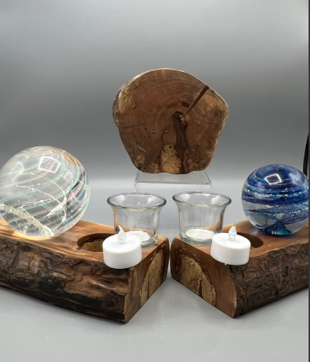 Red Maple Tree of Life display on a carved log base with two votive candles and glass orbs.
