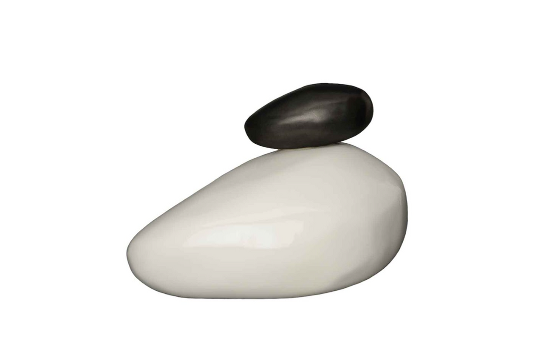Smooth white stone base with a smaller black stone balanced on top