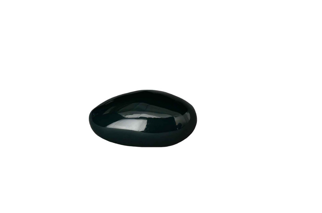 Polished black oval stone pebble