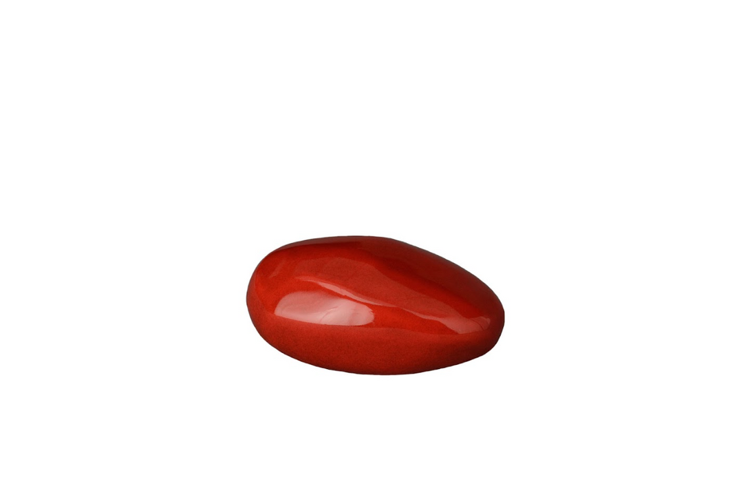 Polished red orange oval stone pebble