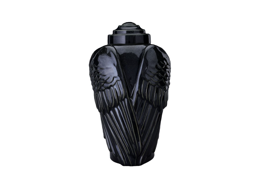 Angels’ Wings Ceramic Urn in glossy black with sculpted wings and a tiered lid.