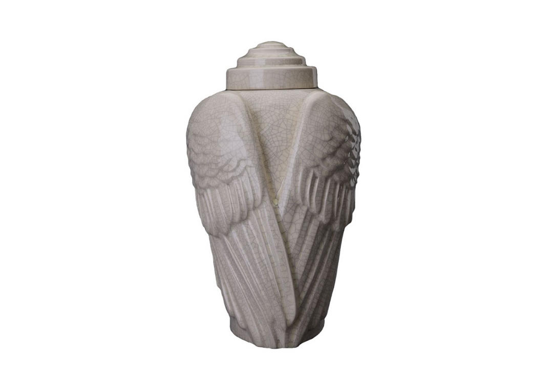 Cream Angels’ Wings Ceramic Urn with crackle glaze and carved feathered wings seen from the back.