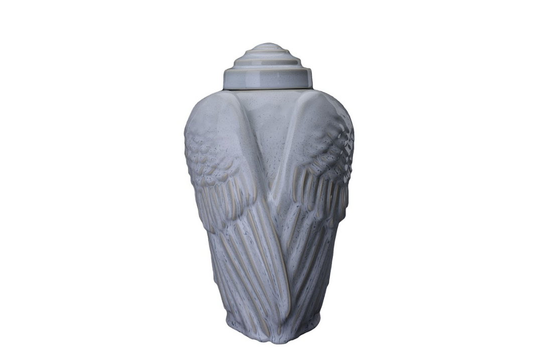 Pale blue Wings Ceramic Urn with sculpted wings on a white backdrop
