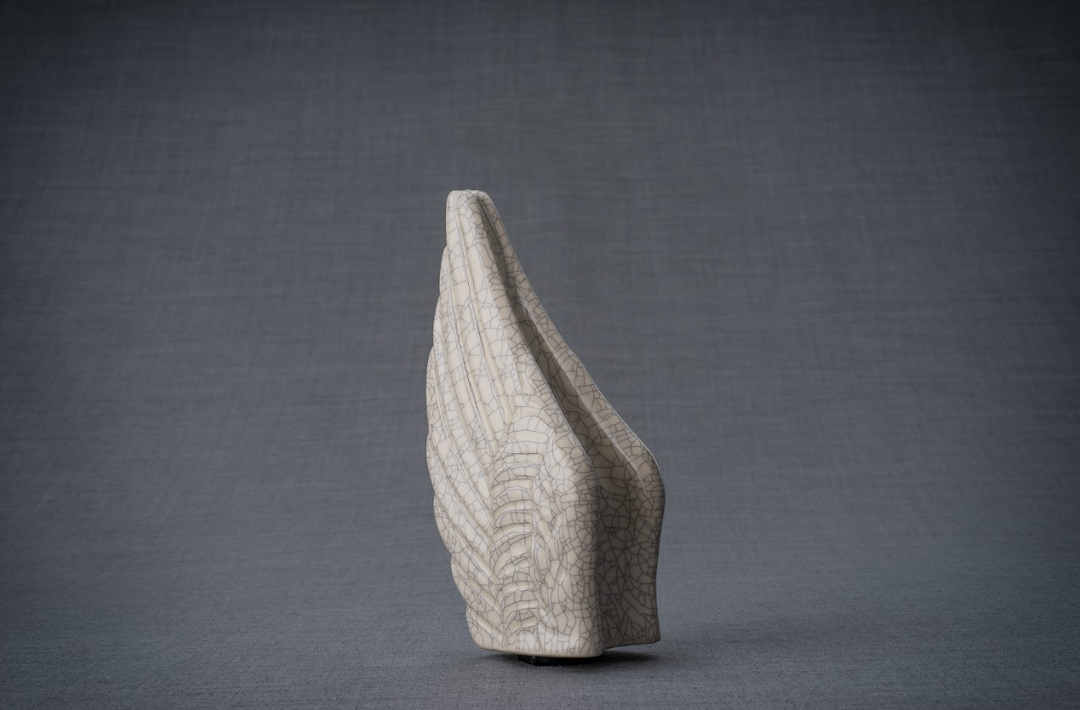 Wings Ceramic Urn with white crackle glaze and fine network of lines against gray background