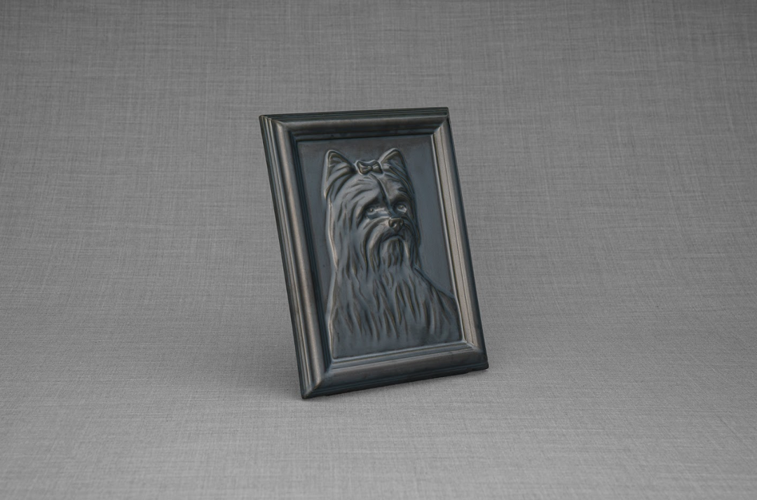 Single Yorkie relief portrait framed and angled upright on a gray textured backdrop.