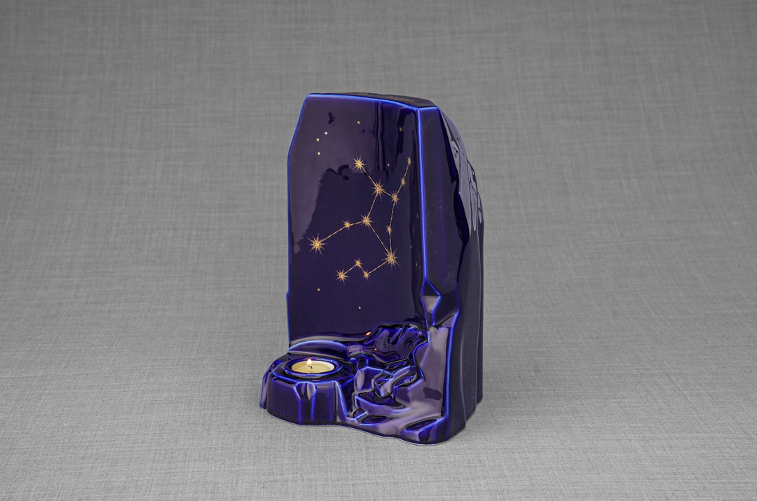Zodiac Ceramic Urn in deep blue glaze with a gold constellation motif and a built in candle holder.