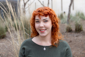 woman wearing sterling silver angel wing cremation pendant