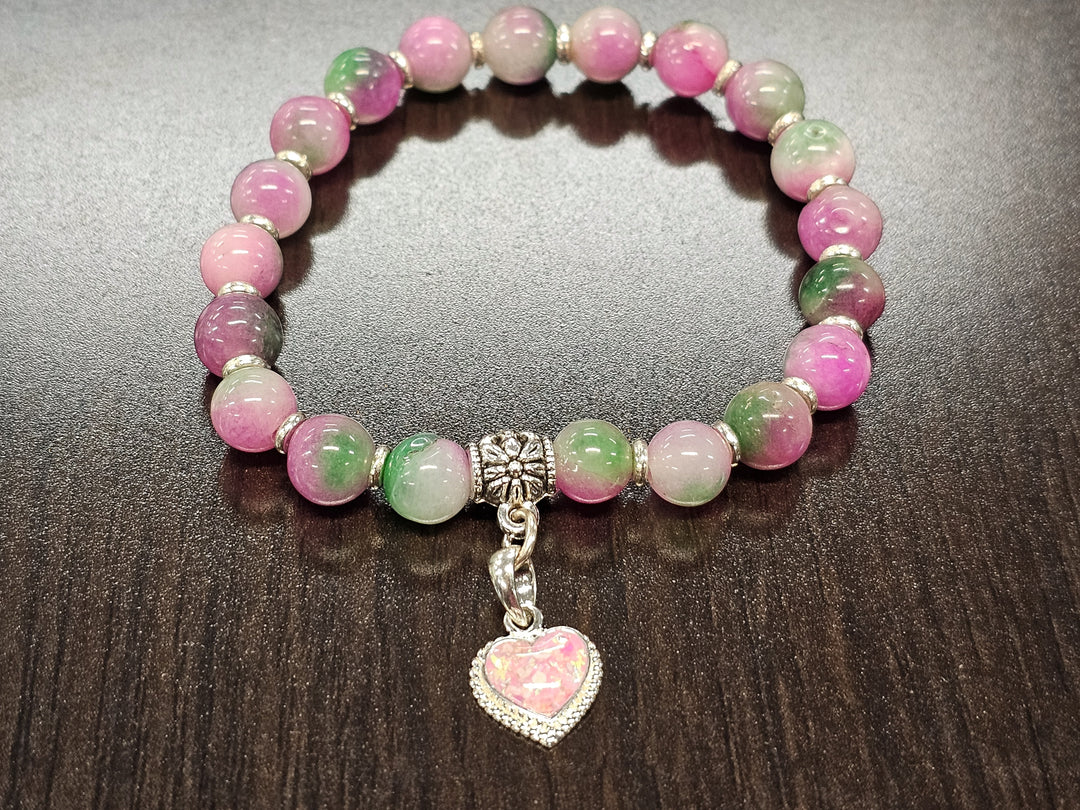 Selenite bead bracelet in pink and green hues with a silver cremation ash heart charm