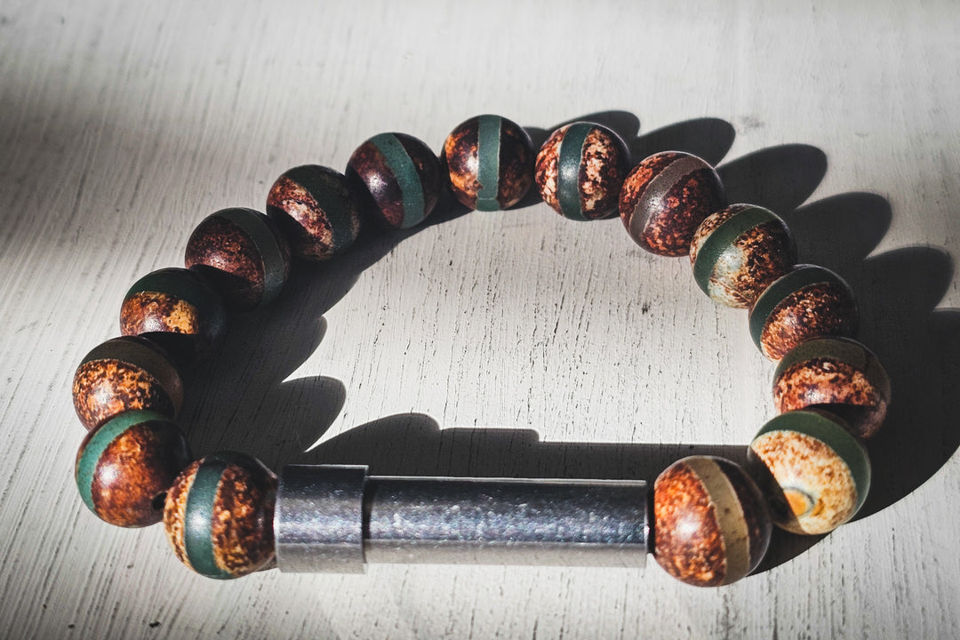 Tibetan Agate bead bracelet with a keepsake urn barrel charm for adding fur or ashes at home.