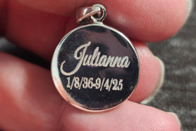 a circle pendant engraved