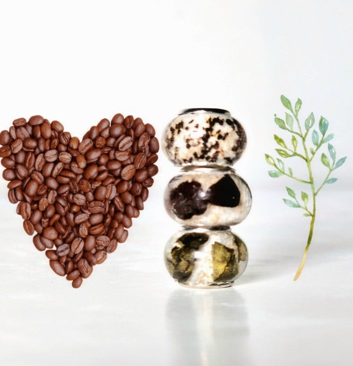 Beads infused with cremation ashes placed beside a heart shaped from coffee beans