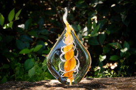 glass flame with cremation ash from pets and people