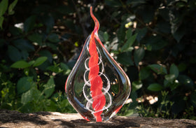 glass flame with cremation ash from pets and people