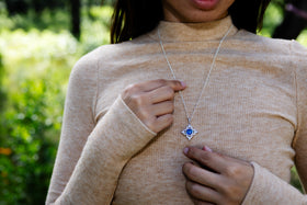starburst pendant being worn by woman