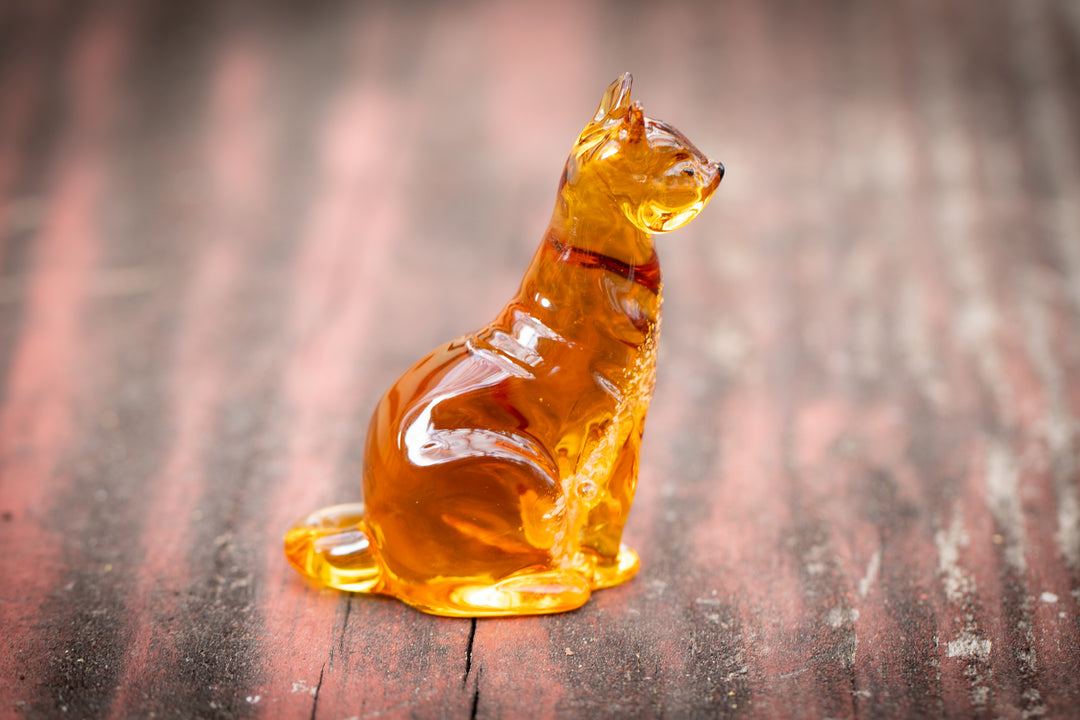 Amber glass cat figurine infused with cremation ashes in the belly, seated