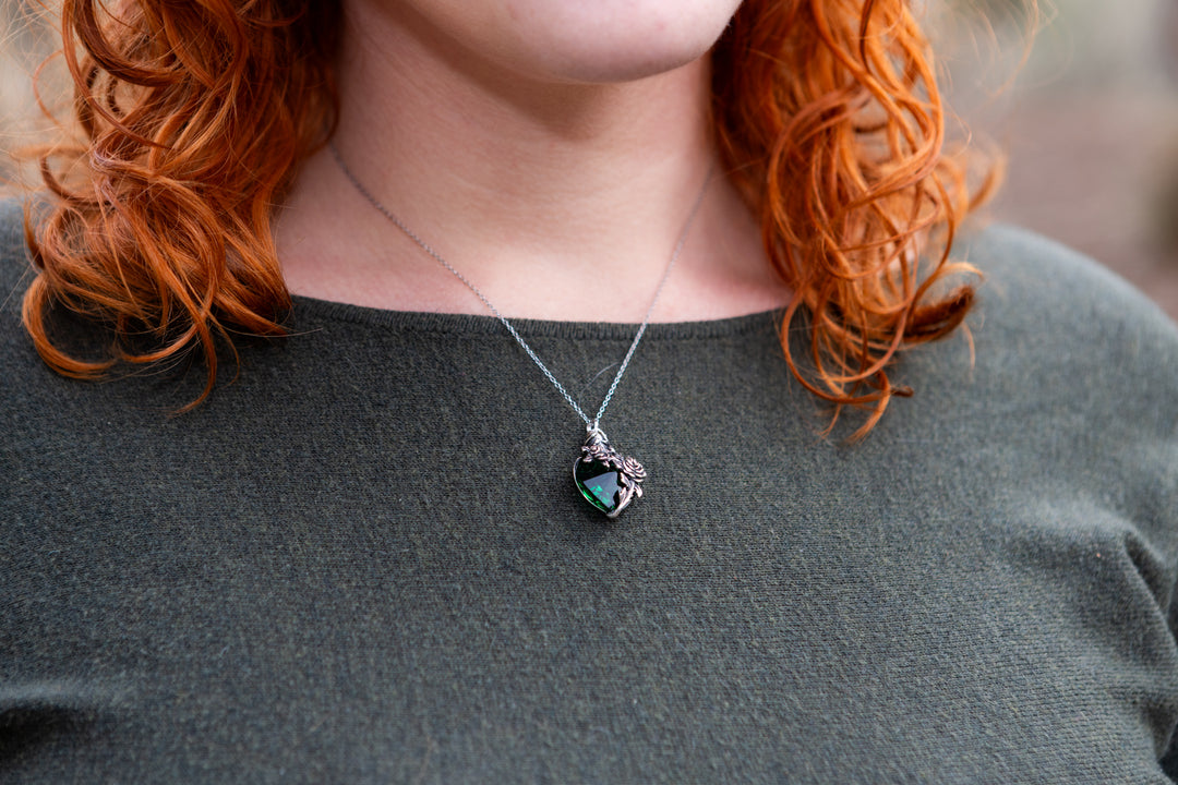 woman wearing cremation pendant emerald with cremation ash