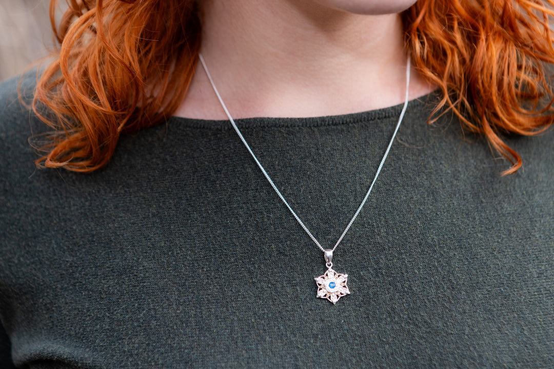 snowflake pendant with cremation ash being worn by woman