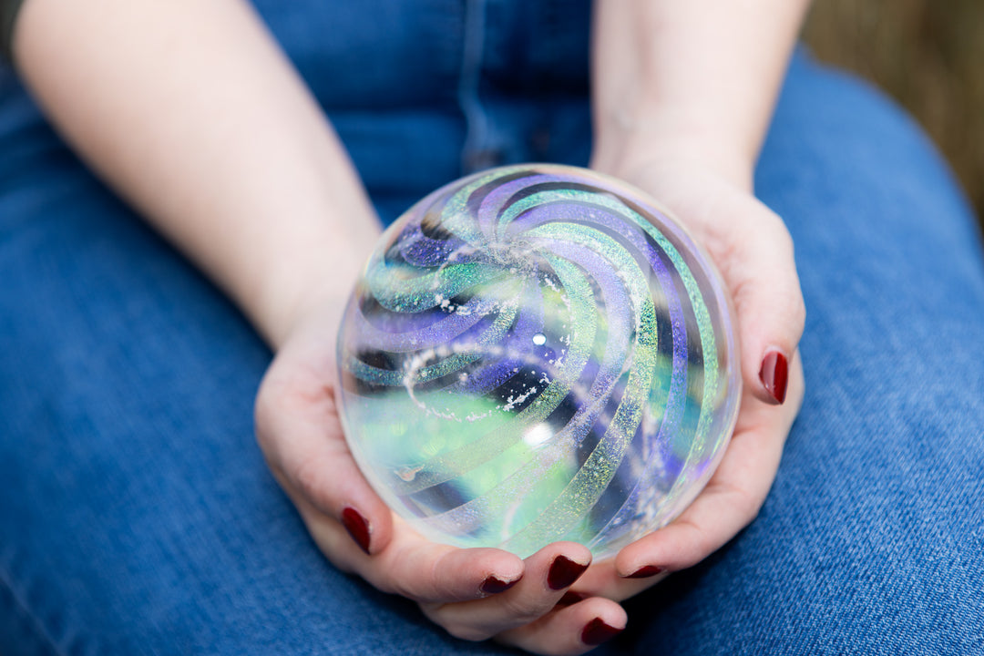 dichroic rainbow orb being held by woman