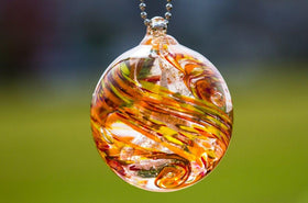 glass orb with ash fall confetti