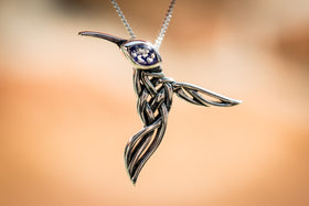 Filigree hummingbird with cremation ash in eye