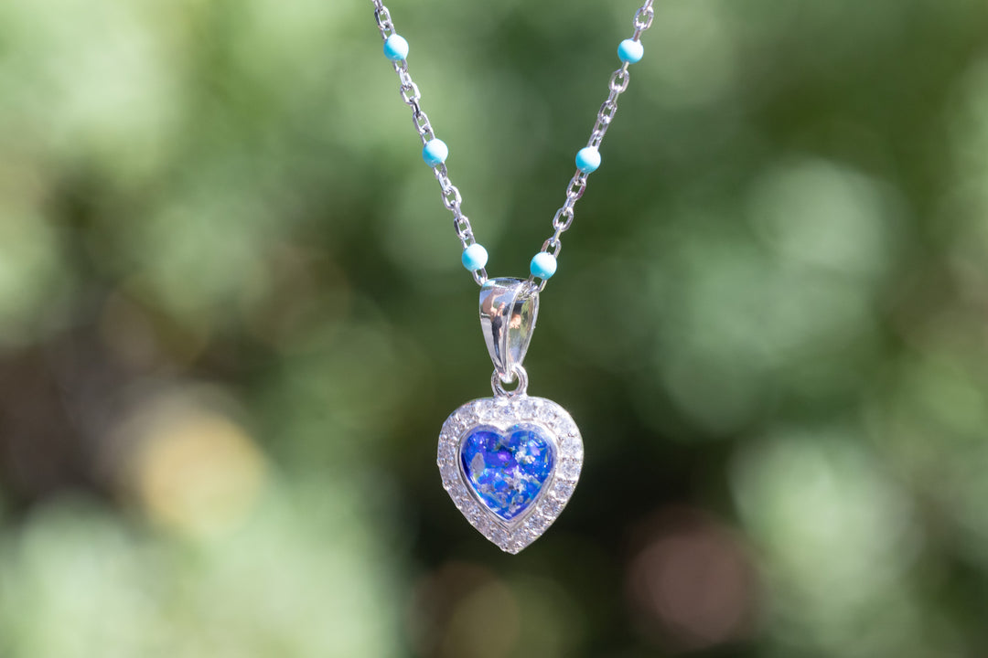 Petite opal heart pendant with crystal surround hanging from a silver chain with small turquoise beads