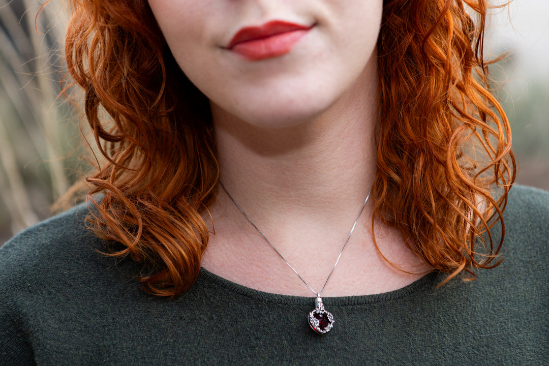women wearing ruby heart cremation pendant