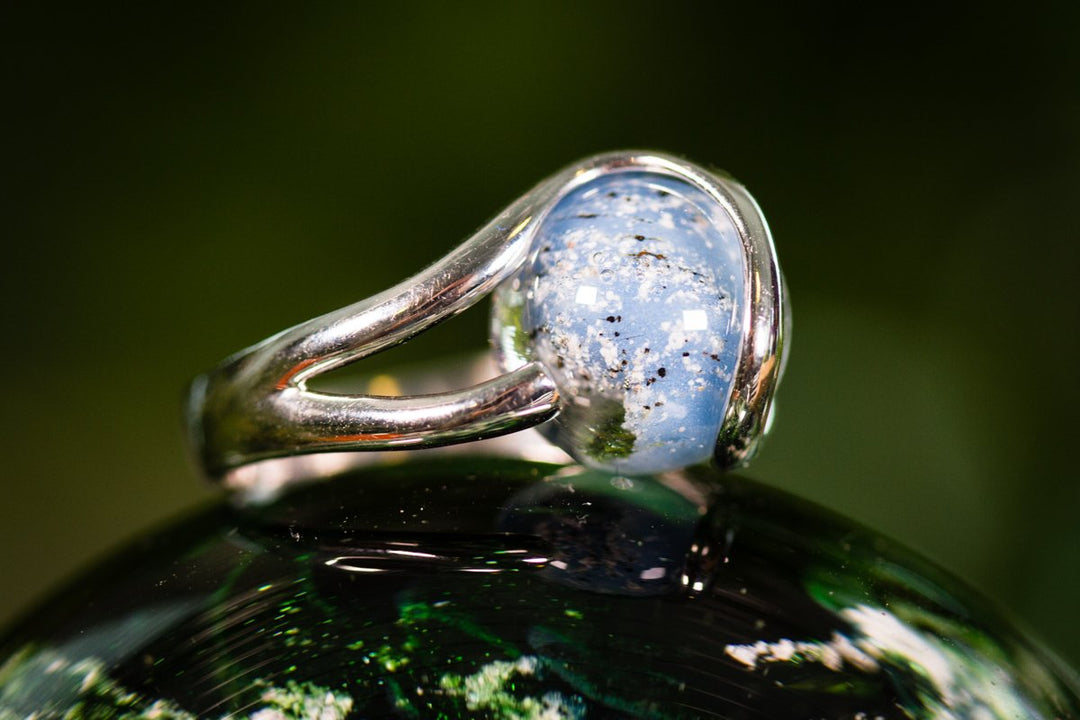 Sterling silver ring with a light blue 12mm glass marble infused with cremation ashes