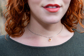 woman wearing gem drop with cremation ash