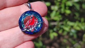 video of cardinal keepsake urn necklace in hand