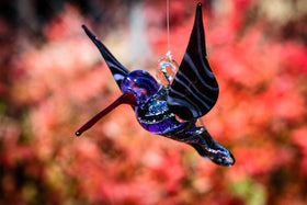 purple dichroic hummingbird with cremation ash