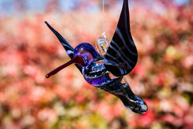 purple dichroic hummingbird with cremation ash