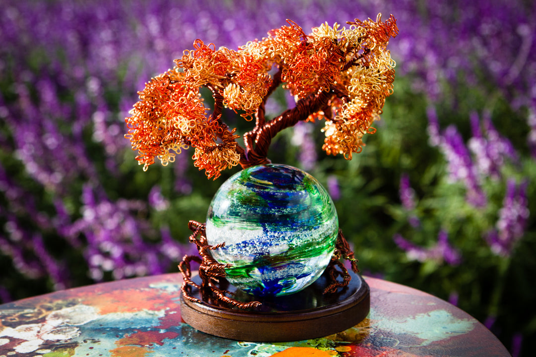 Autumn Sunshine Tree of Life with a Tranquil Swirl Orb on a wooden stand, copper twisted branches against a purple backdrop.
