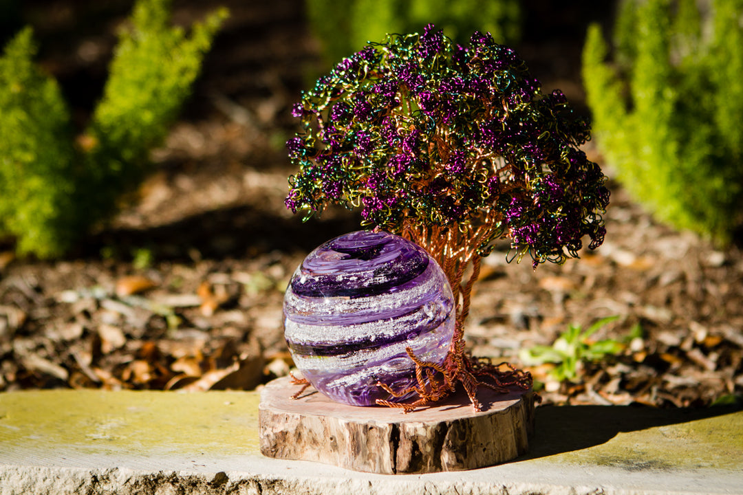 Purple Crepe Myrtle Tree of Life with a 3 inch Sparkle Orb on a wooden stand outdoors.