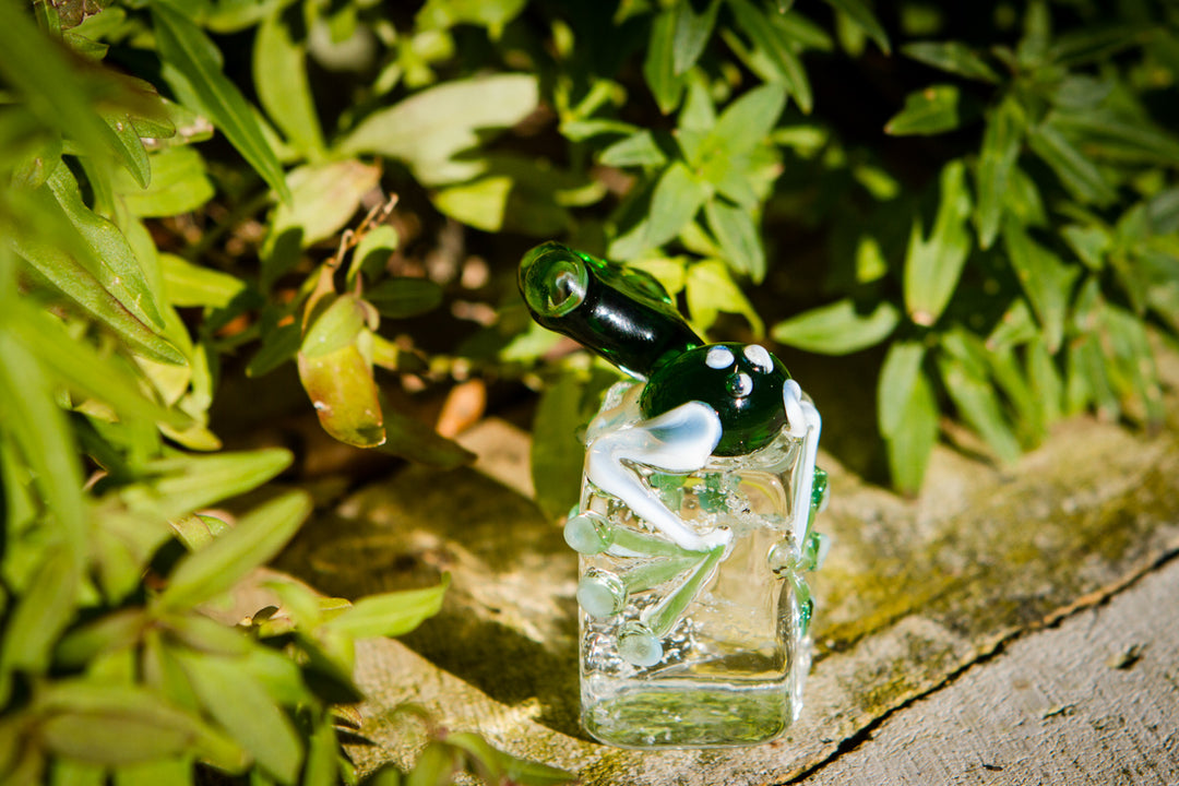 Glass frog keepsake resting on an iceberg base infused with cremation ash for a loved one.