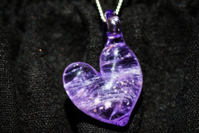 cremation heart pendant with cremation ash in purple on cloth
