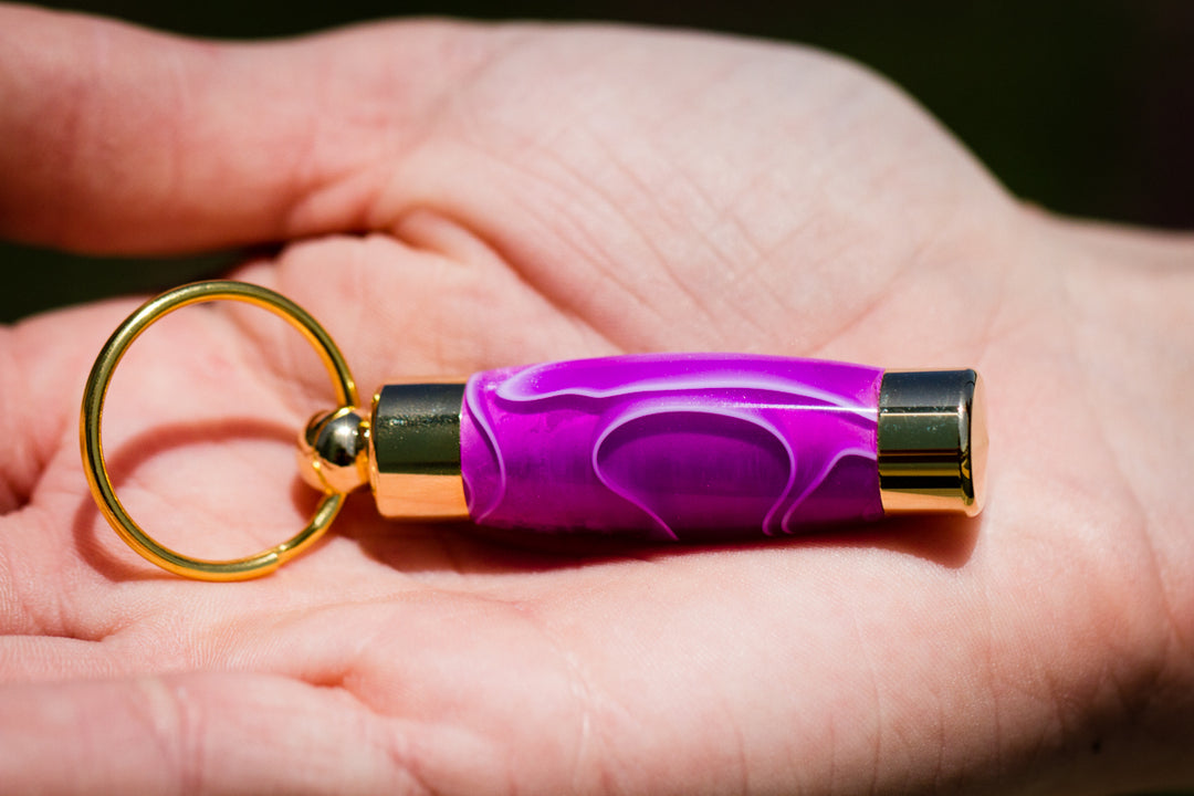 Purple amethyst acrylic keepsake urn pendant with gold ends and a small ring for necklace or keychain