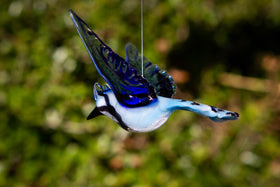 glass bluejay figurine with ashes