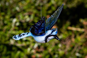 glass bluejay figurine with ashes